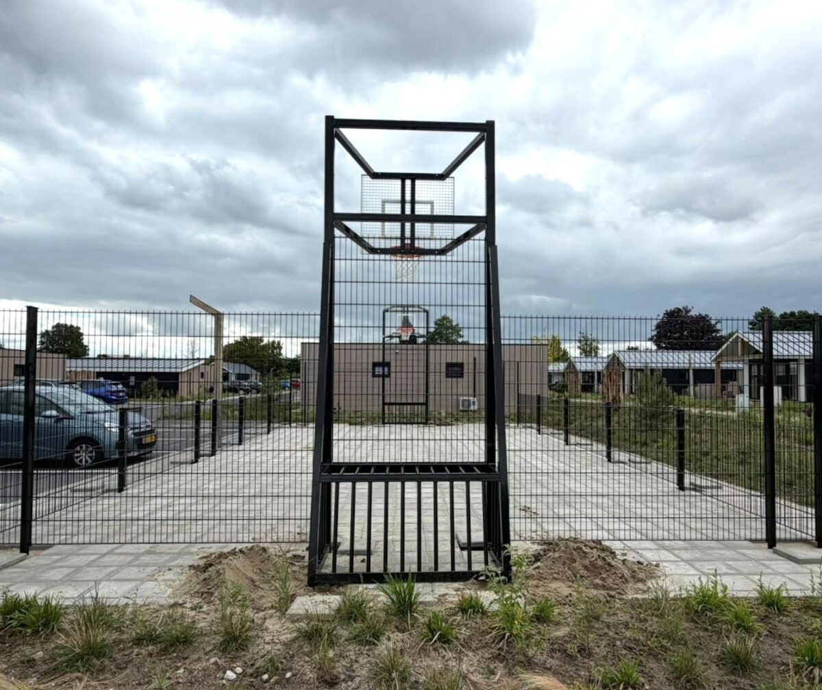 Maatwerk pannakooi met basketbal geplaatst in Yerseke 3 Vandalismebestendig voetbaldoel met geïntegreerd basketbalbord en rode basketbalring in pannakooi